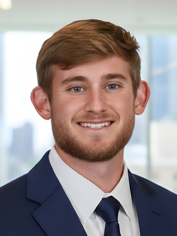 Collin Wheeler, Mortgage Loan Originator at Loan Velocity, smiling in a professional suit against a blurred office background.