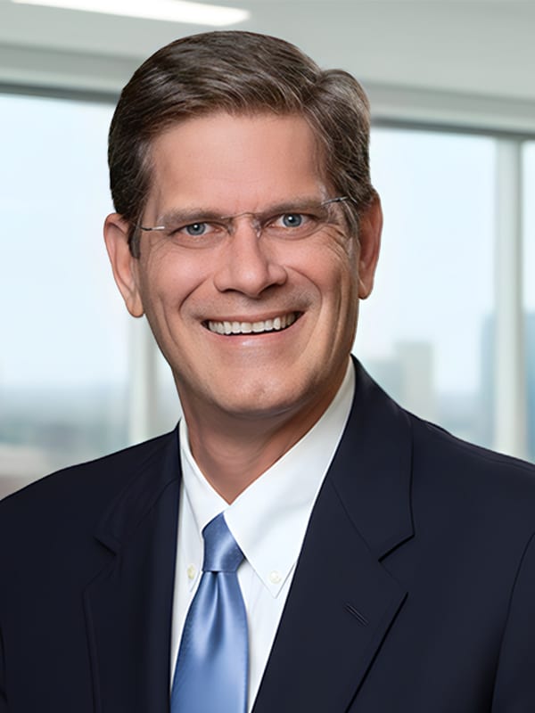 David Thompson, Mortgage Loan Originator at Loan Velocity, smiling in professional attire with a cityscape background, representing mortgage services and client support.
